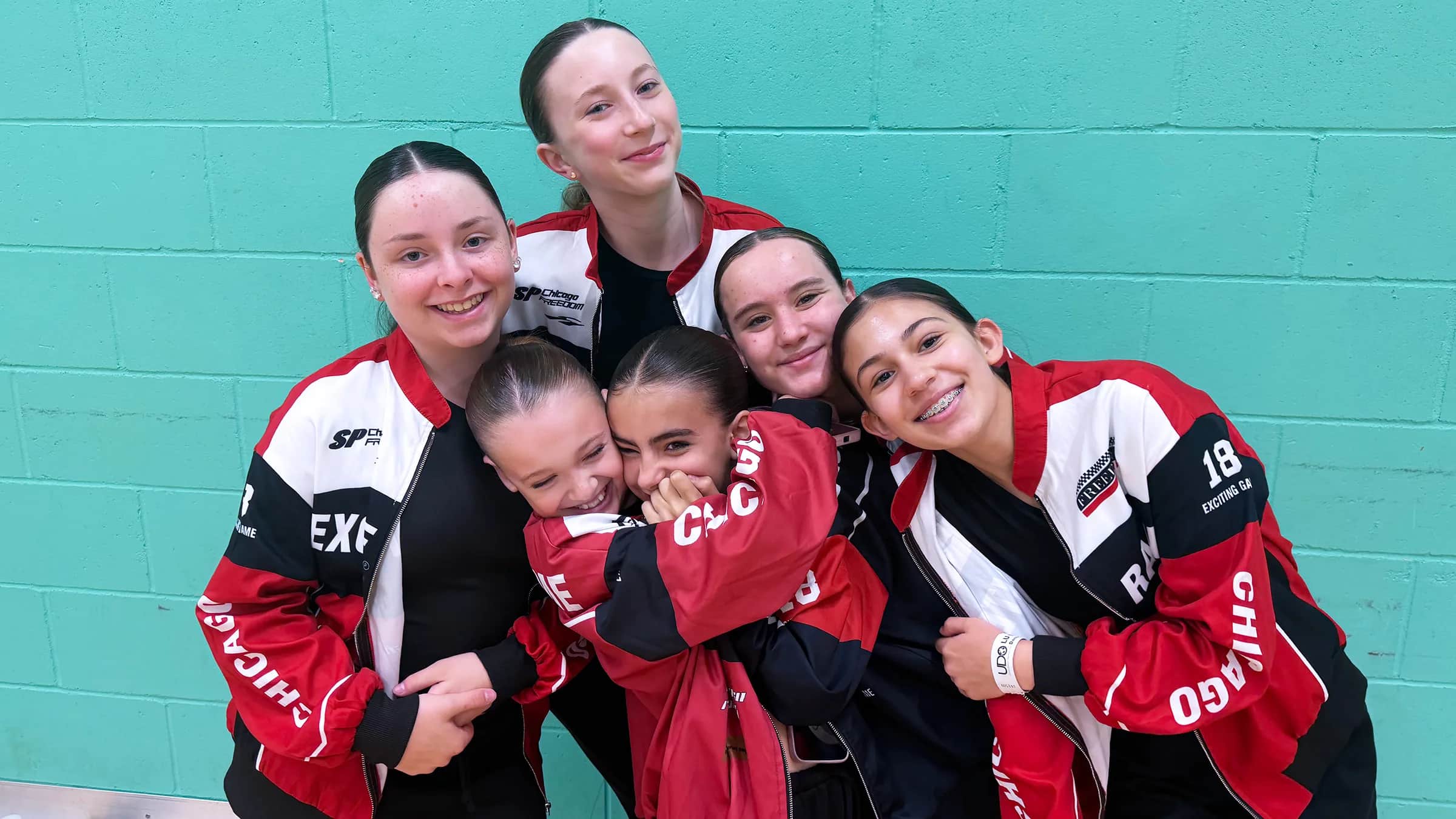 HK Dance Studios dancers laughing together in their team kit