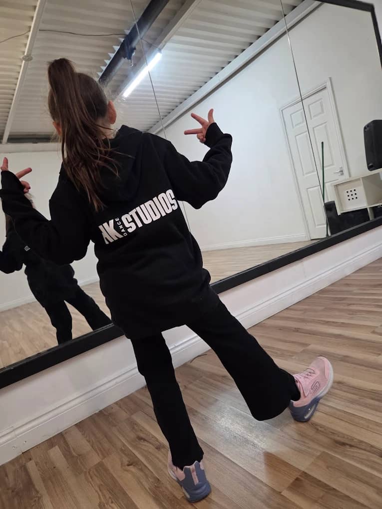 A young dancer holding a hip hop pose at HK Dance Studios Billericay, where the street dance classes for Basildon families run
